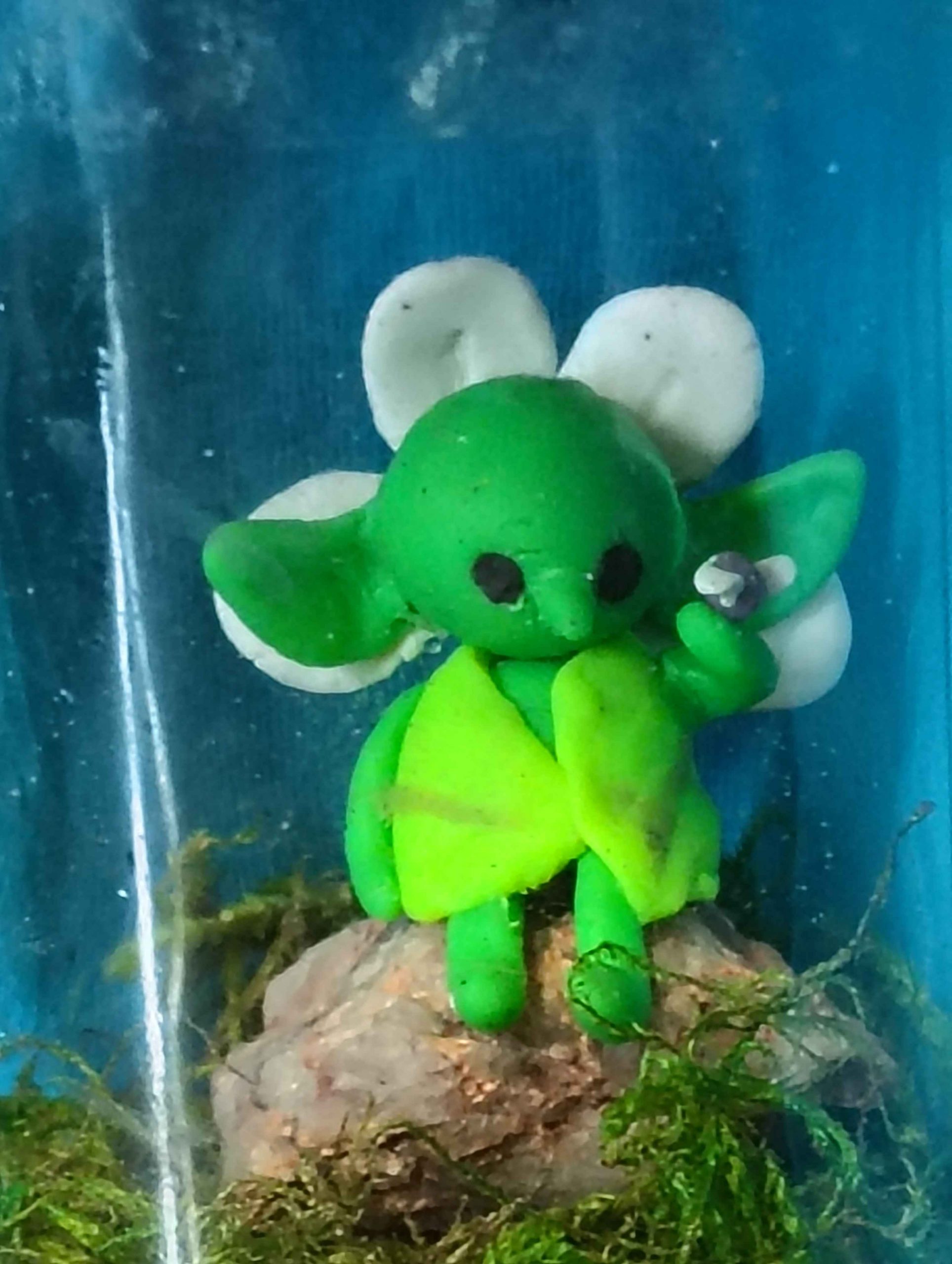 Peaceful Goblin sitting on a rock listening to a fly.